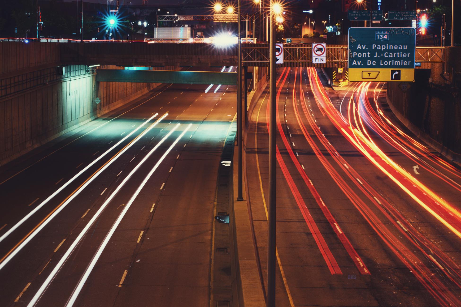 Captivating long exposure shot of city highway traffic light trails at night, emphasizing movement and urban life.