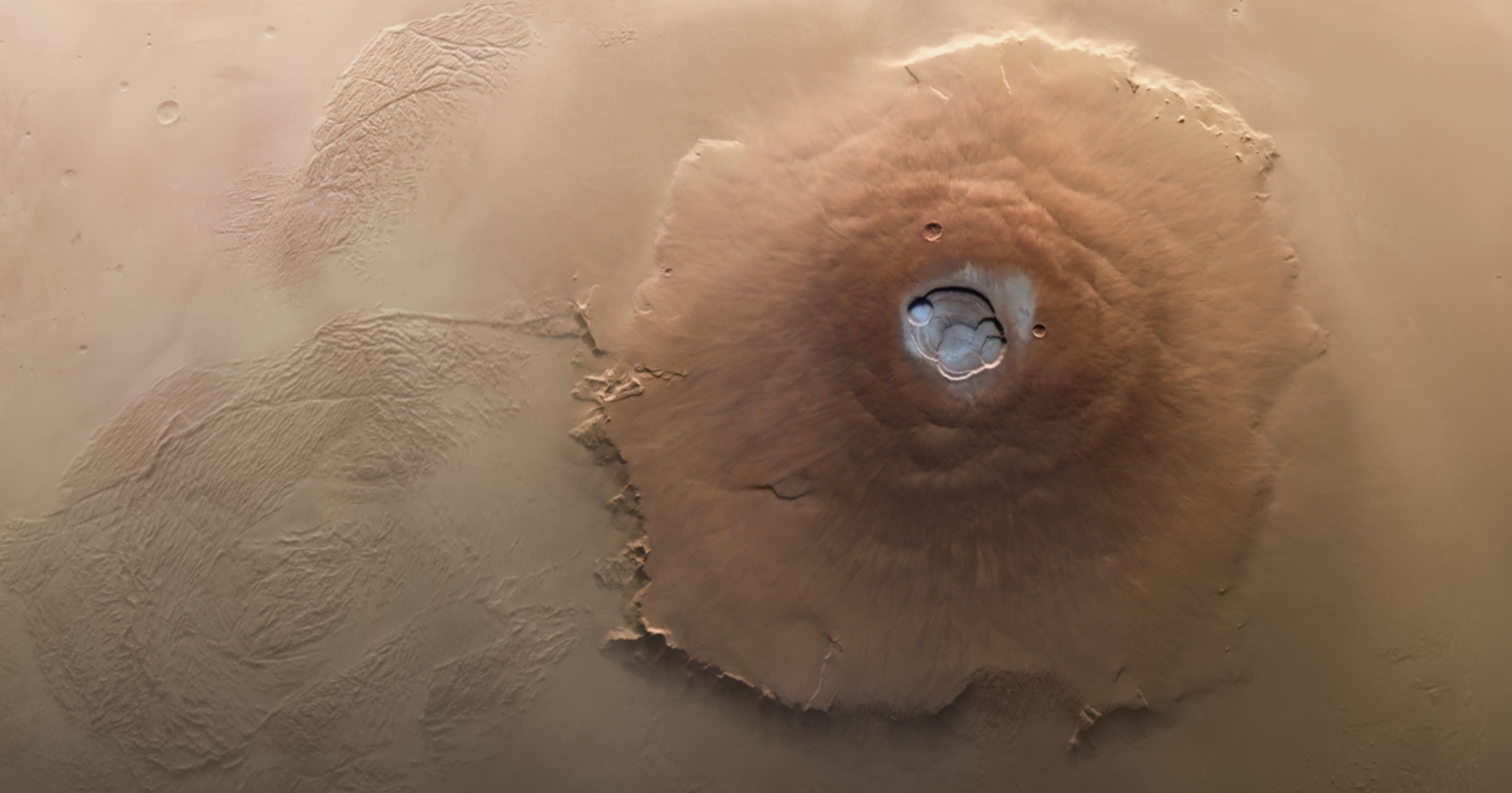 Olympus Mons on Mars rises nearly 22 kilometres above the surrounding plains, three times the height of Everest, but its slopes are so gradual that a person standing on it would not realise they were climbing the largest volcano in the solar system