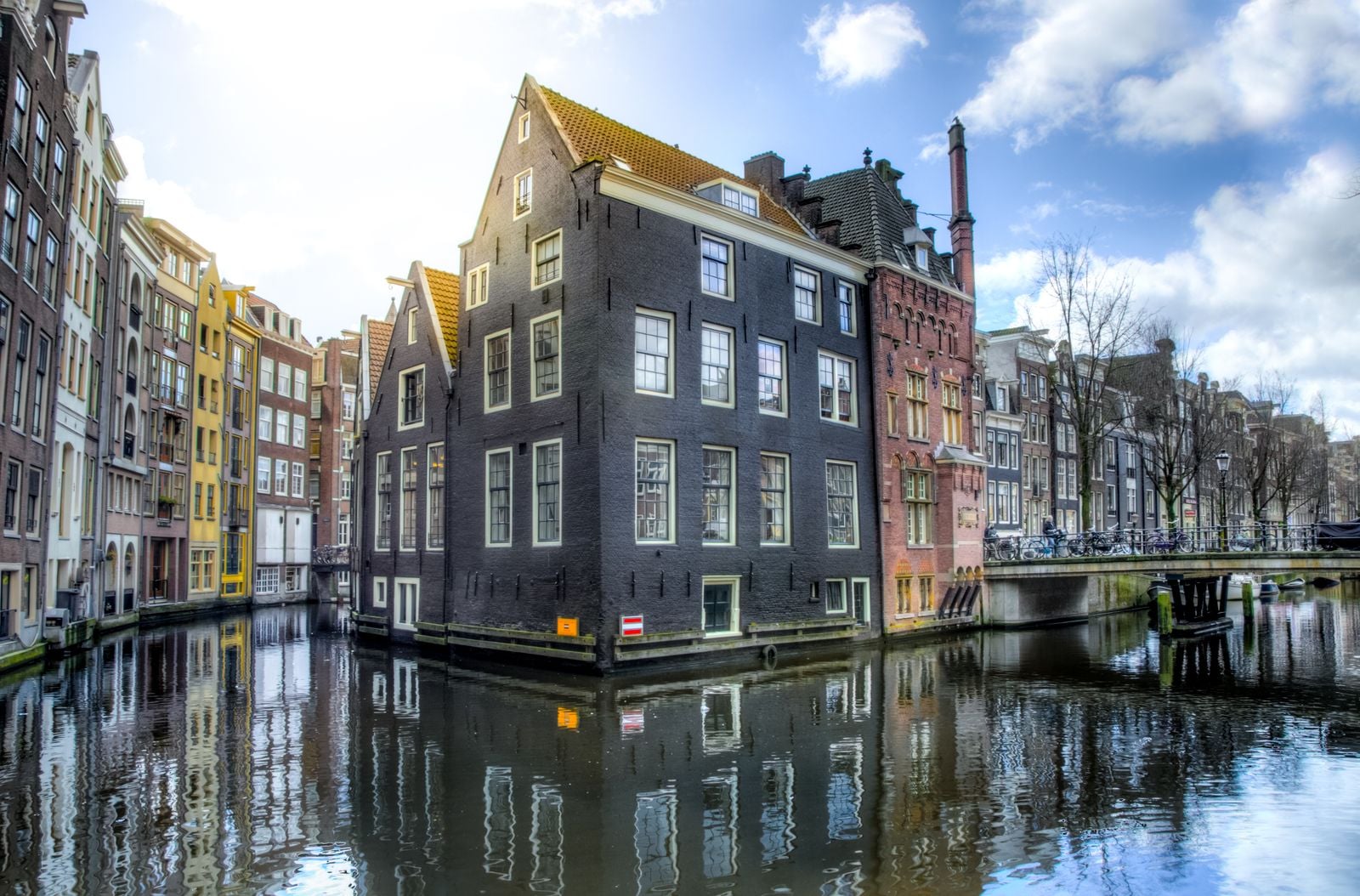 Adyen processes payments for Uber, Spotify, eBay, and Microsoft from an Amsterdam canal house where the engineering team still eats lunch at a single long table, and the company went public worth €7 billion with fewer staff than a midsize hotel