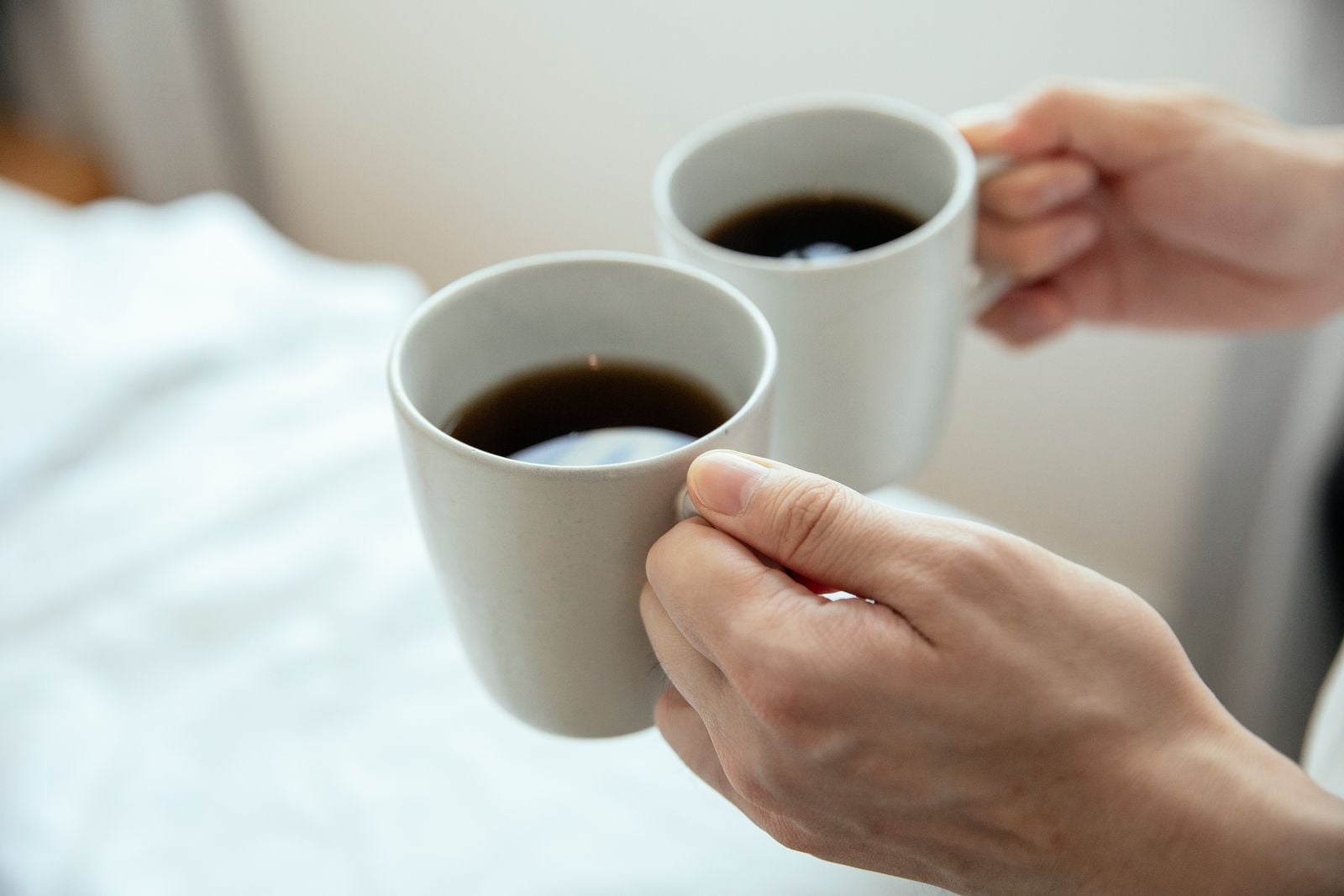 hands holding warm mug