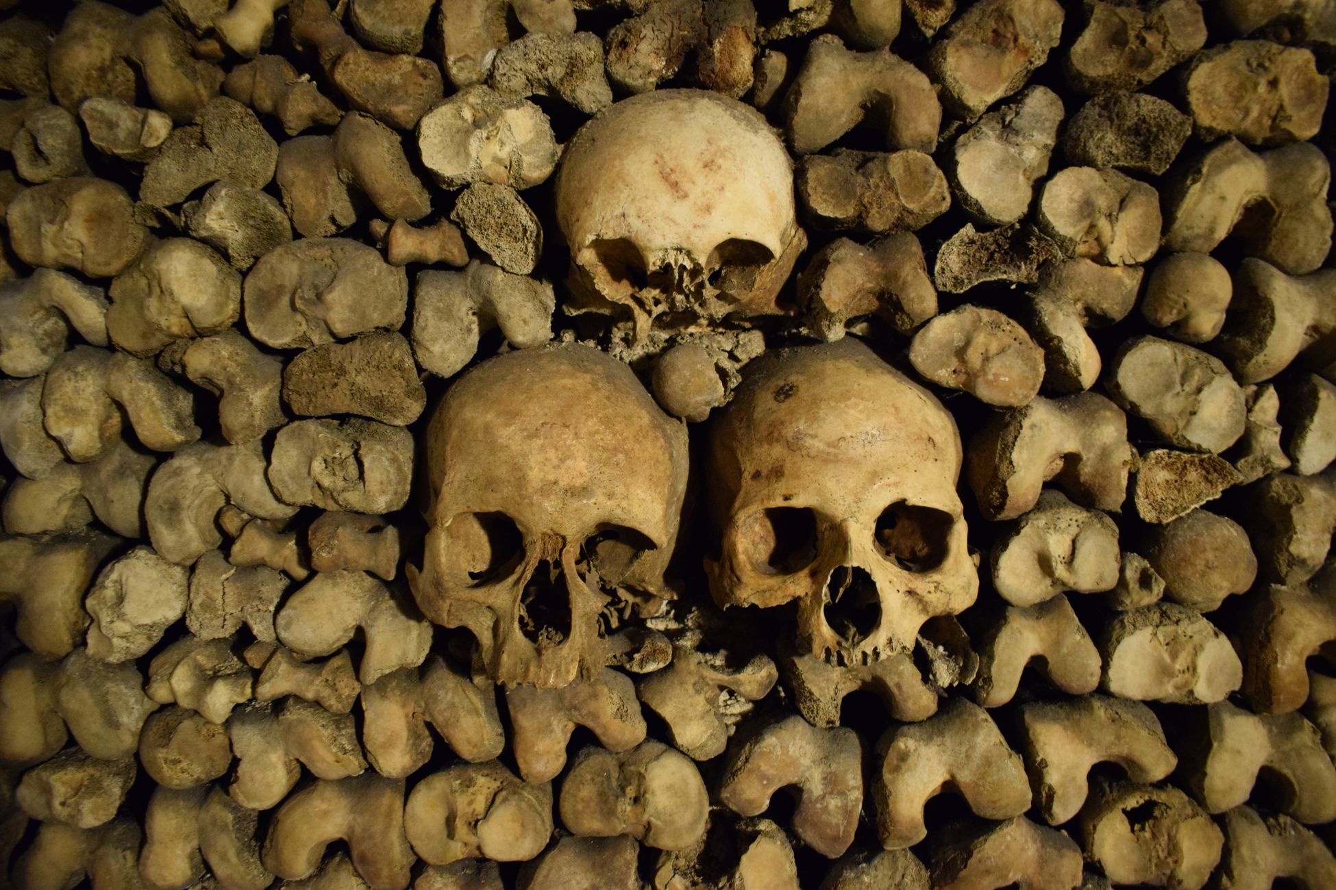 Beneath the streets of Paris lie roughly 200 kilometres of tunnels holding the bones of around six million people, moved underground starting in 1786 to relieve overflowing cemeteries, and only a small lit fraction is open to visitors who descend 20 metres below the city.