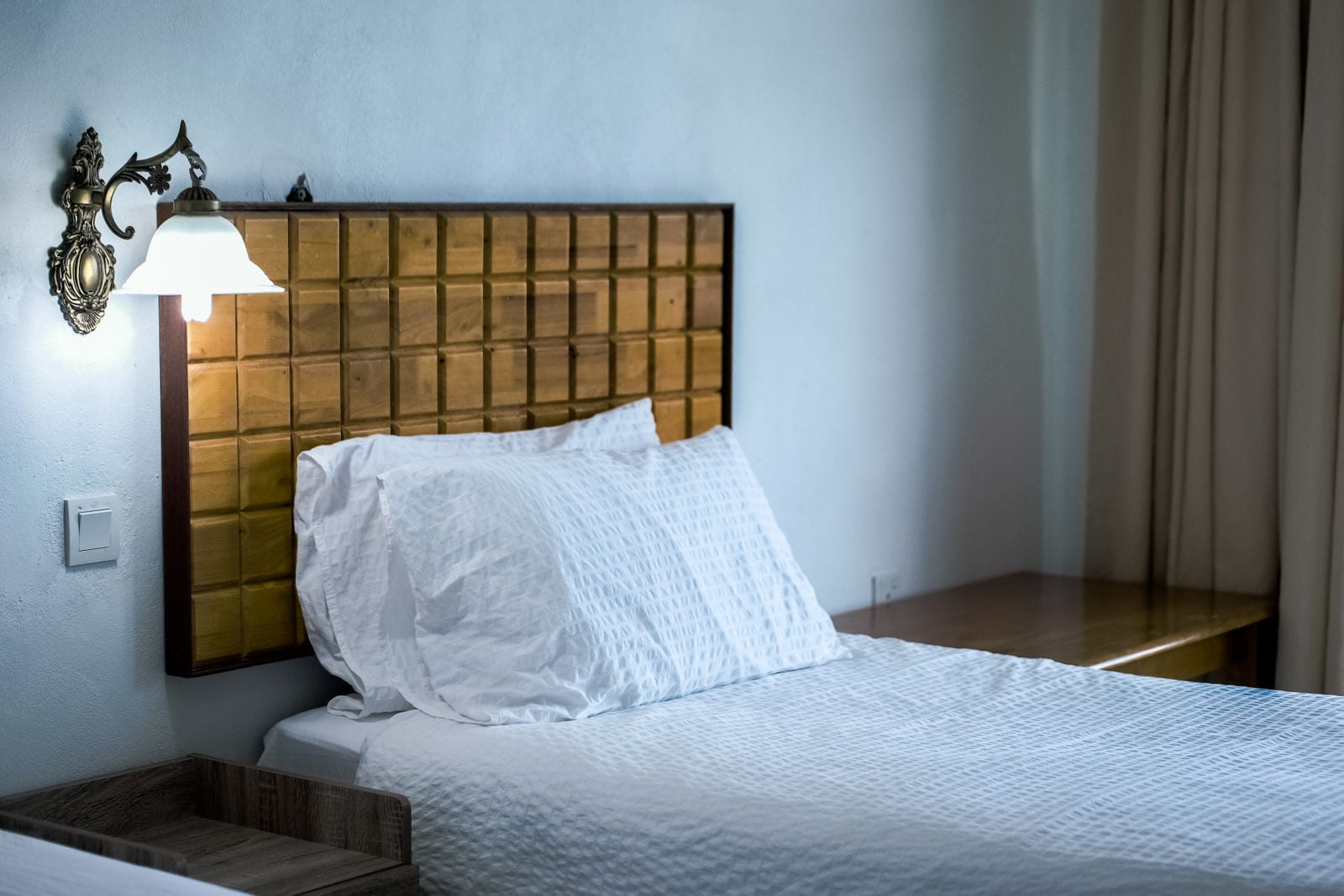Nobody talks about why people in their late 40s suddenly start sleeping better in hotels than at home, and it isn't the mattress or the blackout curtains, it's that hotel rooms have no unfinished tasks looking at them