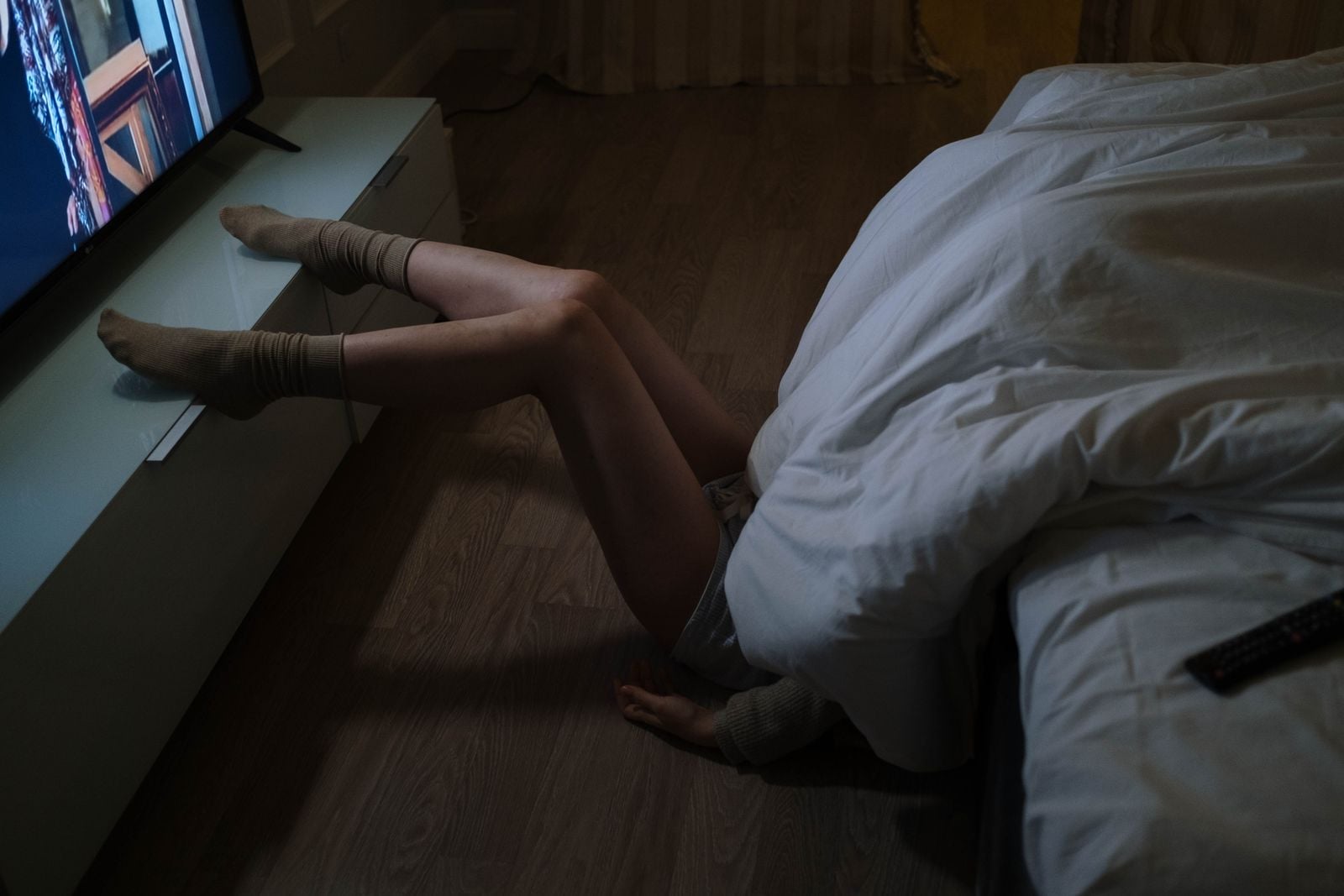 People who fall asleep with the television on aren't lazy or undisciplined — many learned in childhood that voices in another room meant the house was safe, and the nervous system still reads the equation the same way decades later